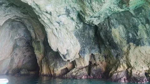 Explore a Cave by the Water in a Quiet Location During the Bright Afternoon Sun Stock Footage 330794713