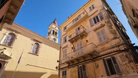 Explore the charming streets of Corfu with historic buildings and sunny skies Video stock 285596338