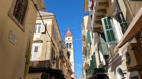Explore the charming streets of Corfu with views of the bell tower on sunny day Video stock 285596328