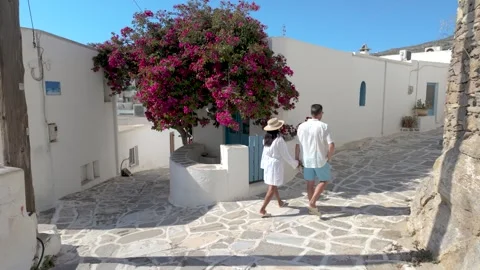 Explore the charming streets of paros greece with vibrant bougainvillea blooms Stock Footage 336528793