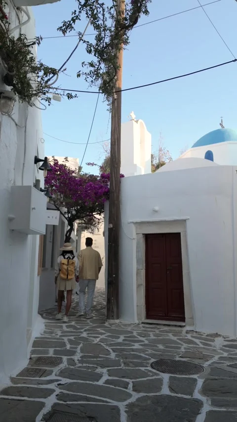 Explore the charming streets of Paros, Greece on a sunny afternoon stroll Stock Footage 337362911