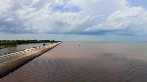 Explore Con Nhan Beach with waves, boats, and clouds in Vinh Long Vietnam Stock Footage 346621159