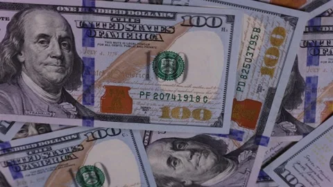 Explore different perspectives of one hundred dollar bills scattered on a Stock Footage 324147023