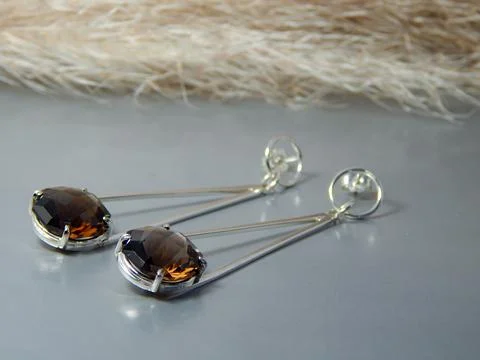 Explore Elegant Dangle Earrings featuring eyecatching Smoky Brown Gemstones Stock Photos