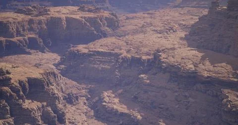 Explore fascinating rock formations in a vast canyon landscape during daytime Stock Illustration