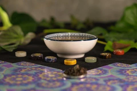 Explore the harmony of chakras with herbal tea and vibrant stones Stock Photos