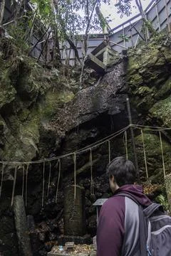 Explore a hidden waterfall at an abandoned site surrounded by lush greenery Stock Photos
