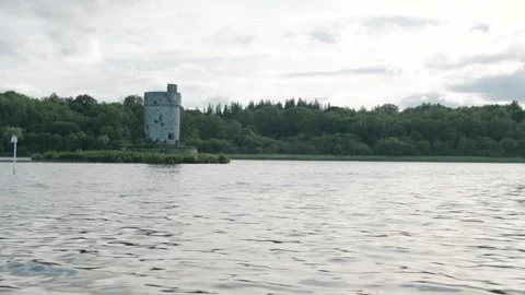 Explore a historic tower on an island surrounded by serene water in action shot Stockbeeldmateriaal 306394182