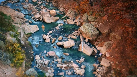 Explore hot spring autumn natural pool surrounded by vibrant foliage Stock Footage 310218385