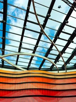 Explore an innovative architectural design with vibrant waves under a sleek g Stock Photos