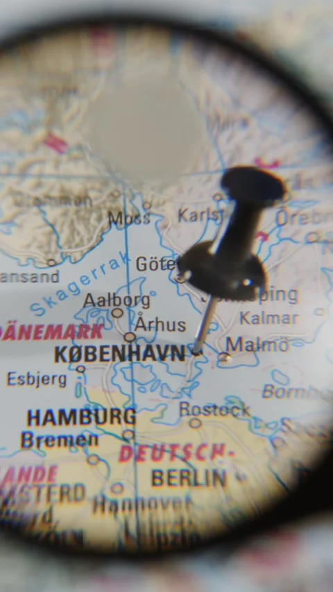 Explore Kobenhavn on a paper map using a magnifying glass Stock Footage 340078848