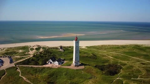Explore a lighthouse by the coast with wide views of the beach and ocean du.. Stock Footage 339940052