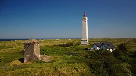 Explore a lighthouse site with a historical tower and coastal view in Denma.. Stock Footage 339940320