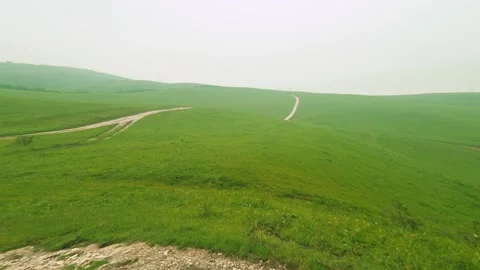 Explore the lush green hills and gentle valleys filled with vibrant grass and Video stock 314282453