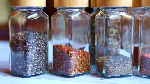 Explore the many bottles of spices neatly arranged on the shelf. Each bottle Video stock 274489501