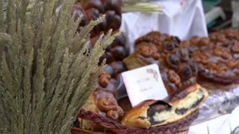 Explore a market stall with baked goods and dried plants in a busy area Stock Footage 339500739
