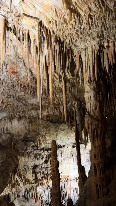 Explore nature view inside dark cave. Tourist attraction: caves stalactites and Stock Footage 346297414