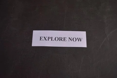 Explore Now Text on White Paper with Black Background Travel Concept Fotos Stock