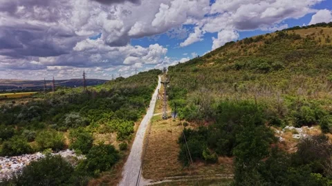 Explore an old railway path through green hills and clouds Stock Footage 339649283
