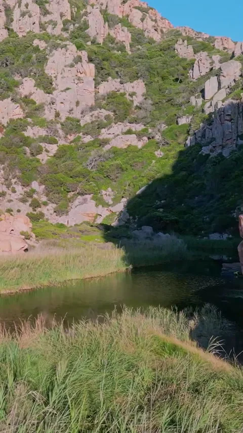 Explore a rugged gorge at Monte Ruju, Sardinia. Towering rocks, lush vegetati Vídeo Stock 310046772