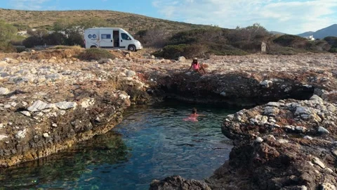 Explore the serene shores of Paros, Greece with stunning rock formations and Stock Footage 336529706