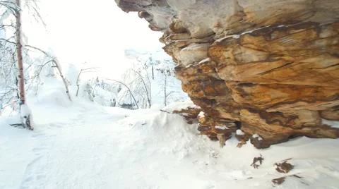 Explore the snow covered trails among the layered rocks on a sunny day 스톡 동영상 59609739