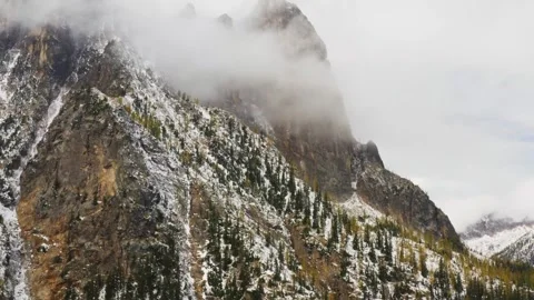 Explore snowy mountains and clouds in a serene landscape 動画素材 320293521