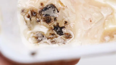 Explore spoiled cheese with mold and discover its unique texture and smell Stock Footage 320602002