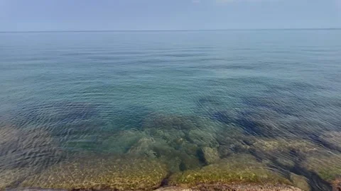 Explore the Stunning 4K Sea Landscape with Crystal Clear Waters and Rocks" Stock Footage 328243569