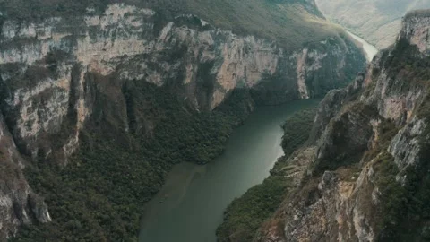 Explore the stunning canyon landscape with flowing river views Stock Footage 320303954