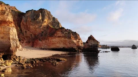 Explore the stunning cliffs and coastal beauty of algarve in portugal at sunrise Stock Footage 313285180