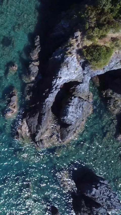 Explore Stunning Coastal Cliffs and Crystal Clear Waters in a Remote Natural Stock Footage 317750876