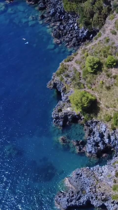 Explore the Stunning Coastline With Crystal Clear Waters and Rugged Cliffs in Stock Footage 317750879