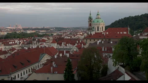 Explore the stunning rooftops of Prague at dawn with a view of St. Nicholas Stock Footage 283795581