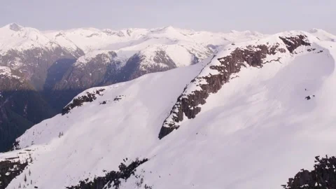 Explore stunning snow-covered mountains at sunrise 動画素材 320341011