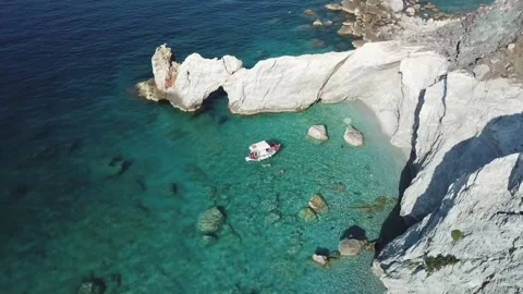 Explore a tranquil cove with clear waters and rocky shores Stock Footage 301735249