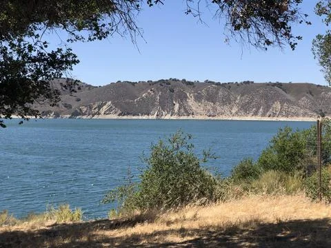 Explore Tranquil Waters and Stunning Hills on a Sunny Day by the Lake Stock Photos