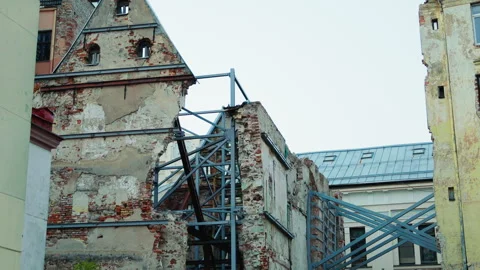 Explore Urban Ruins featuring Structural Support and a Weathered Facade Stock Footage 314344743