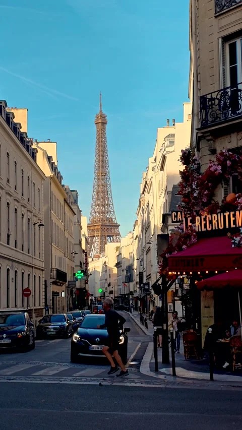 Explore the vibrant streets of Paris with the Eiffel Tower in the background Stock Footage 347260442
