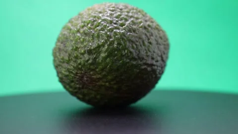 Explore the vibrant world of avocados as they spin in mesmerizing motion on a da Stock Footage 328634815