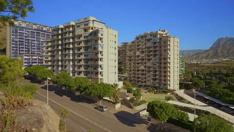 Explore the views of Benidorm with buildings and roads during a sunny day from d Stock Footage 337151956