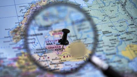 Explore vilnius with a close-up view of a printed map and magnifying glass Stock Photos