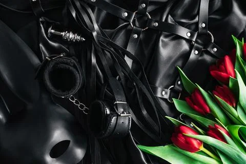 Explore the world of kinky play. Top view of bdsm leather kit whips, handcuff Stock Photos