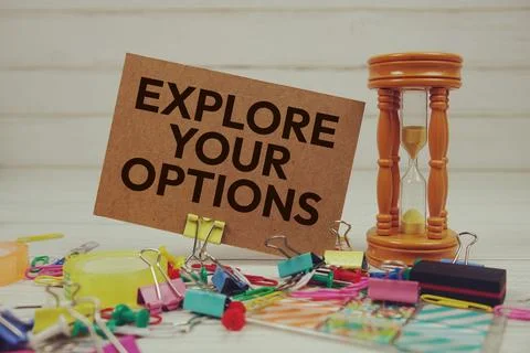 Explore Your Options text on paper card with hourglass and stationary on wo.. Foto stock