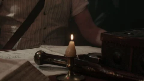 Explorer Captain writes something under candlelight Stock-Footage 259699086
