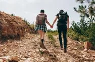 Explorer Couple Trekking A Hill Stock Photos