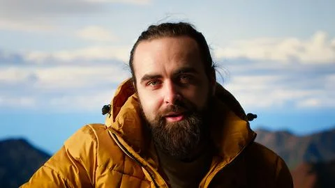 Explorer embraces the thrill of reaching a mountain summit and relaxing Stock Photos