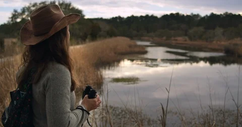 Explorer girl looking for wildlife while hiking Stock Footage 127539591