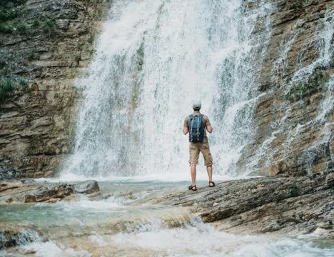 Explorer man and waterfall Stock Photos