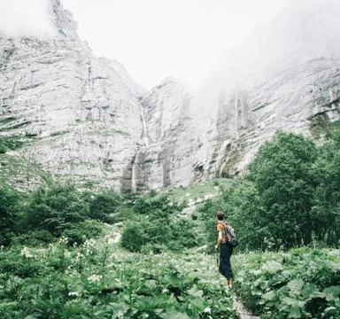 Explorer man going to waterfalls. Stock Photos